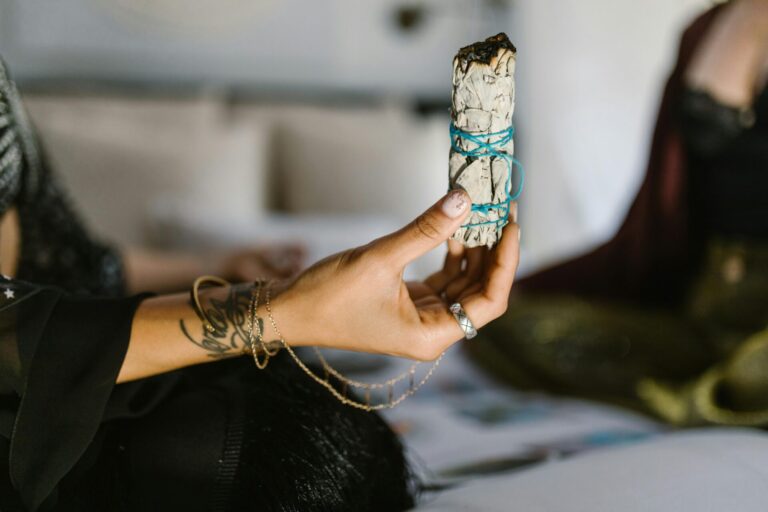 Woman holding incense during a quiet moment to create full moon ritual for release and clarity.