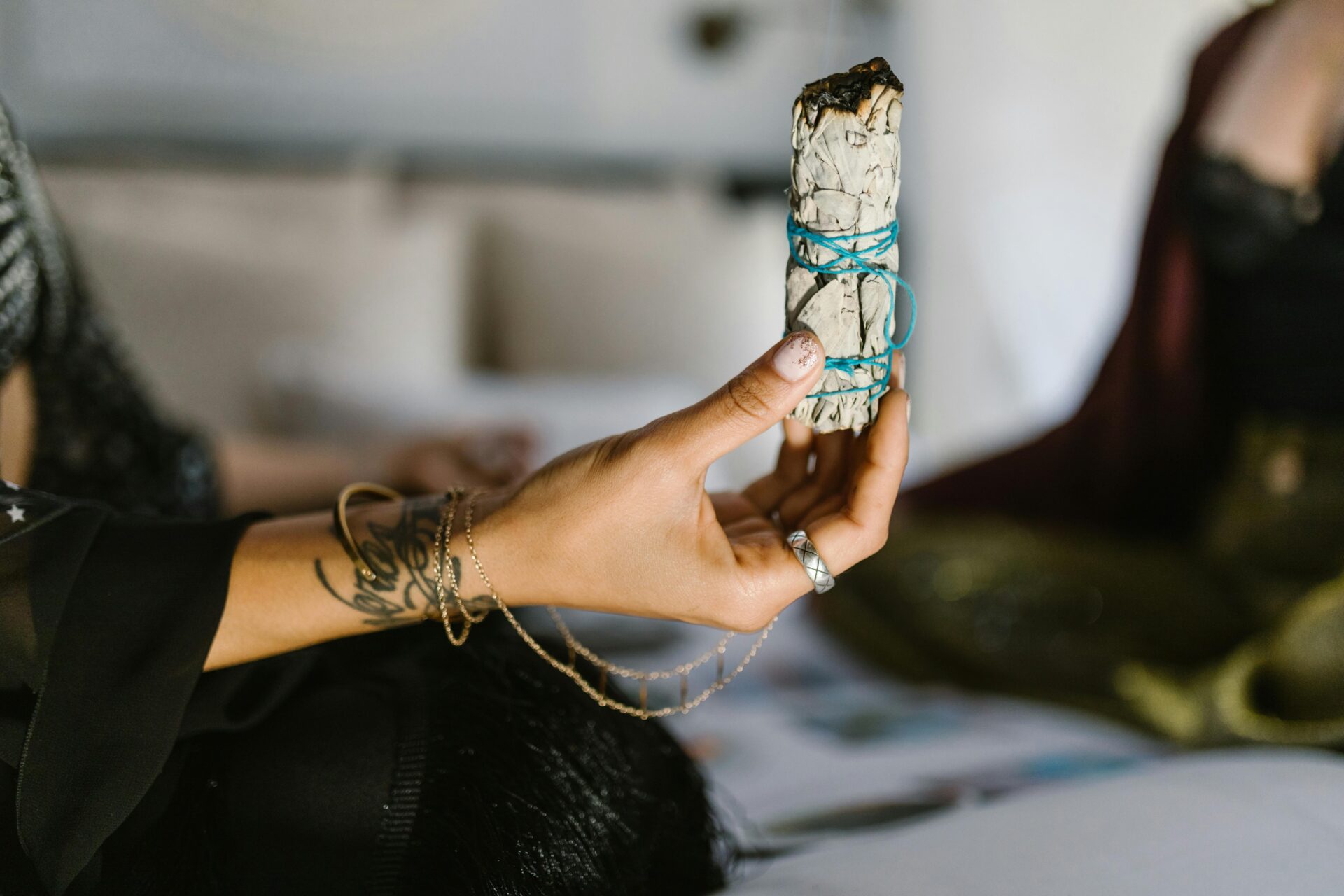 Woman holding incense during a quiet moment to create full moon ritual for release and clarity.