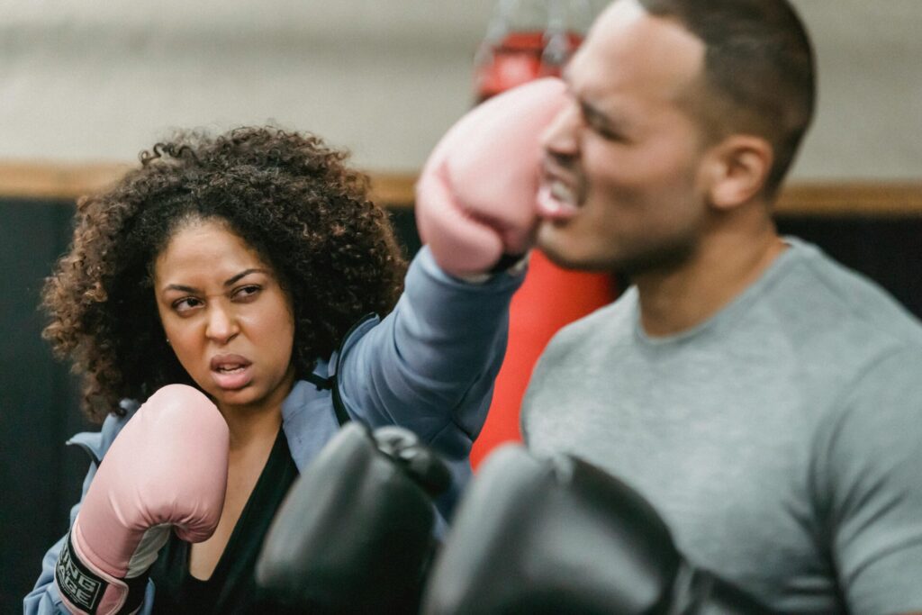 Couple fighting in a boxing ring, symbolizing toxic behavior in a relationship where conflict becomes aggressive, hurtful, and emotionally damaging.