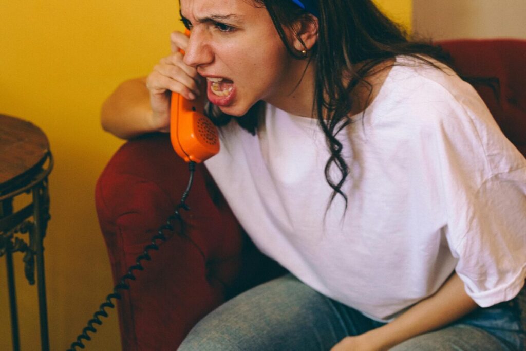 Woman frustrated on phone, tips to manage anger in relationships