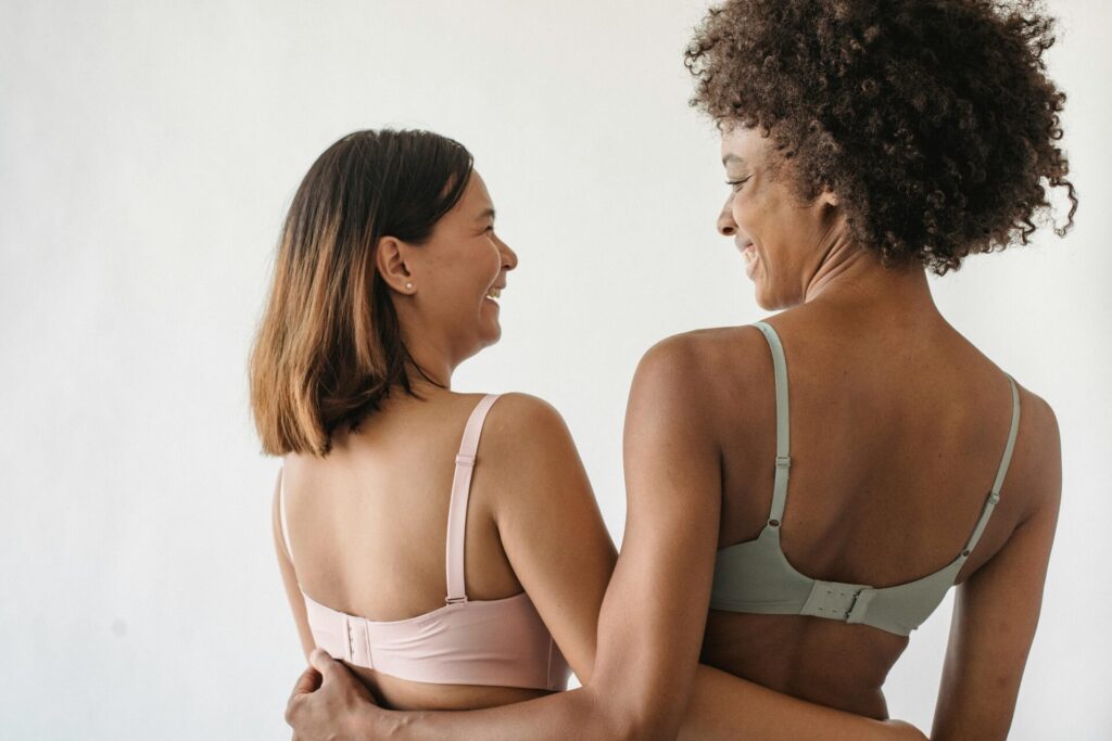 Young women happily embracing, illustrating emotional healing and how to forgive someone who hurt you