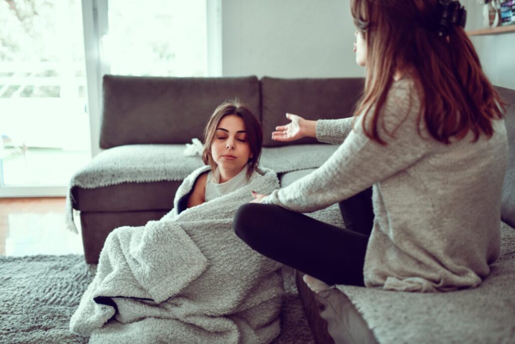 Woman crying after a breakup while her friend comforts her during heartbreak