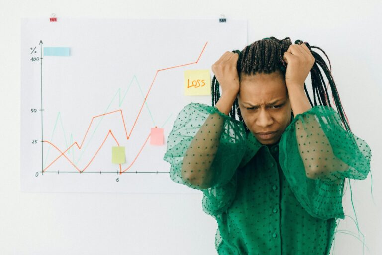 Woman holding her head in frustration, illustrating the challenge of managing fear of failure in life.
