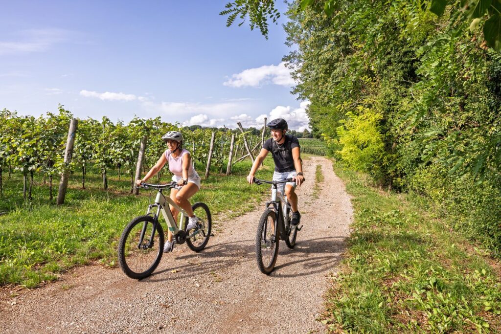 Couple riding bicycles on a sunny day, perfect outdoor budget friendly date idea.