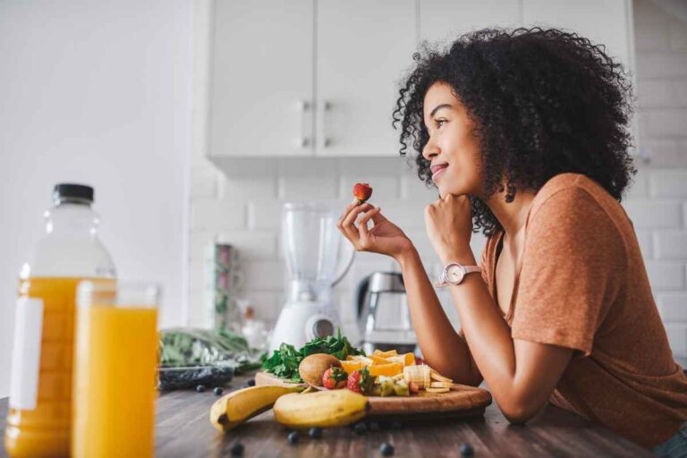 Solo date idea for women: woman sitting alone and smiling, enjoying her own company and peaceful moment