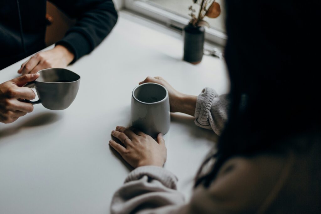 two people talking and drink coffe- ways to overcome fear of judgment