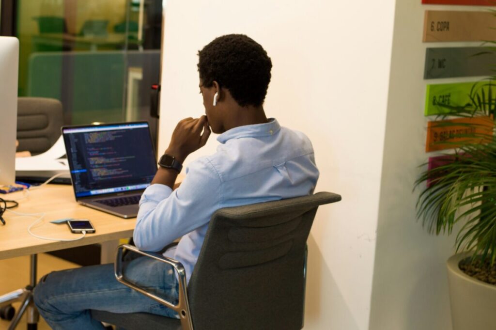 Man working intently on his computer, applying strategies on how to improve focus at work.