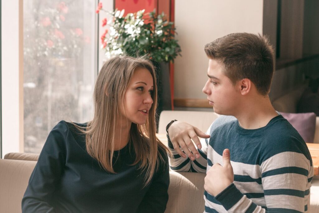 couple talking in a cafe using body language and communication skills