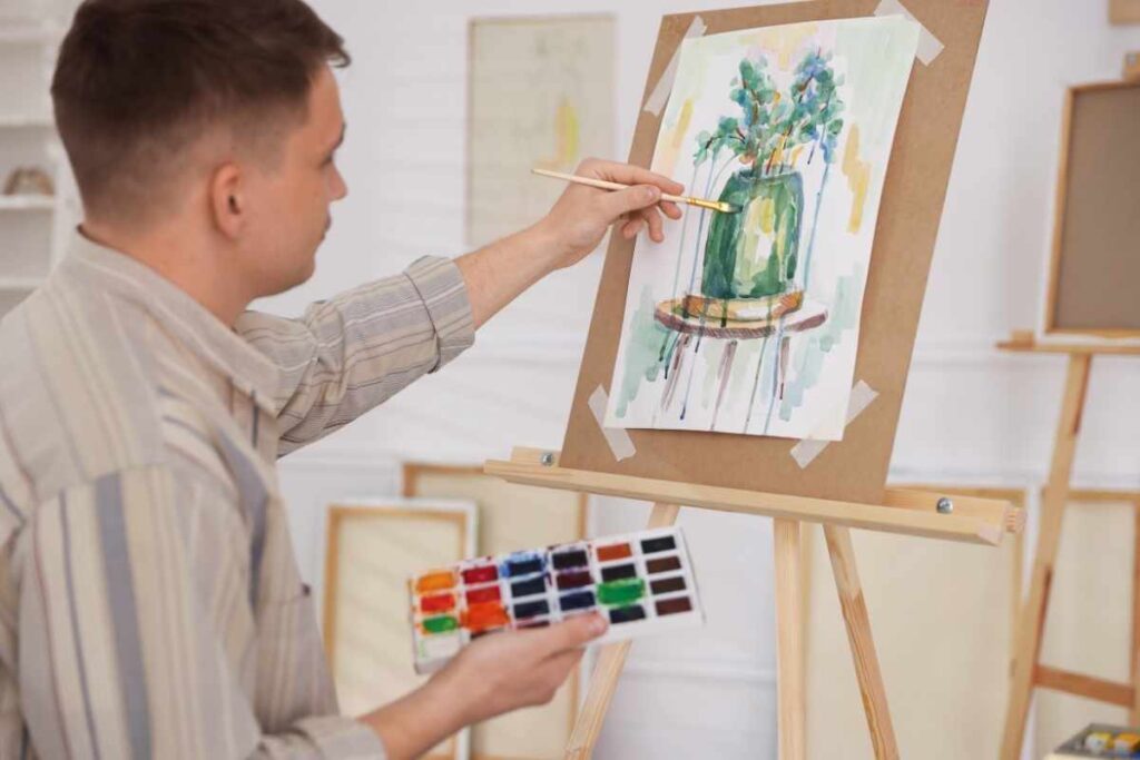 Solo date ideas for men: man expressing creativity by painting on a canvas during his personal alone time