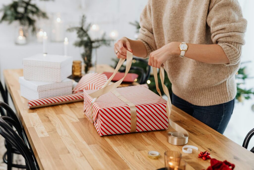 Ways to combat holiday stress: woman peacefully wrapping a gift, enjoying mindful holiday activities