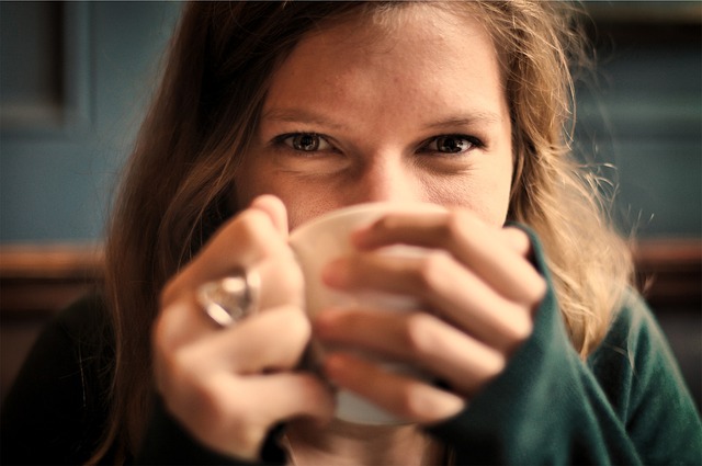 "Woman quietly sipping from a cup, reflecting on why positive affirmations don't work in her daily routine.