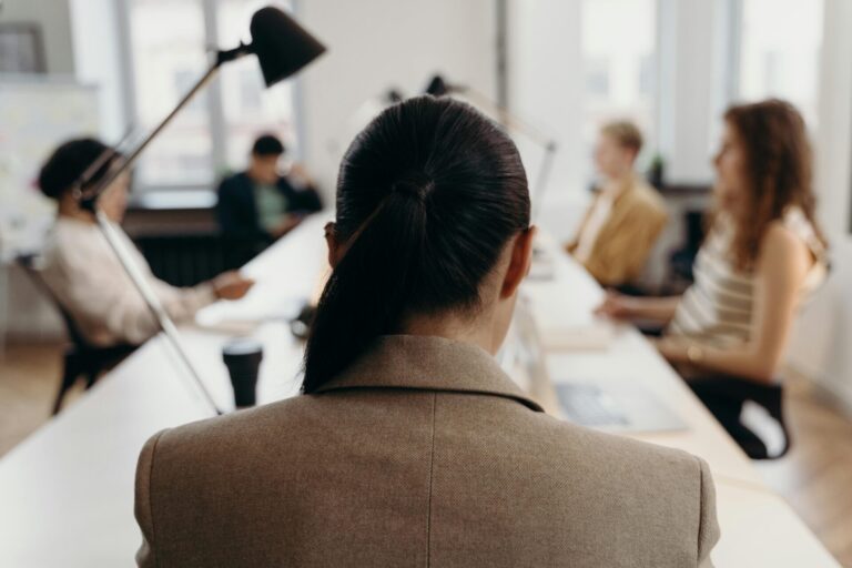 Woman attending a work meeting, representing focus and mindset supported by positive affirmations for productivity.