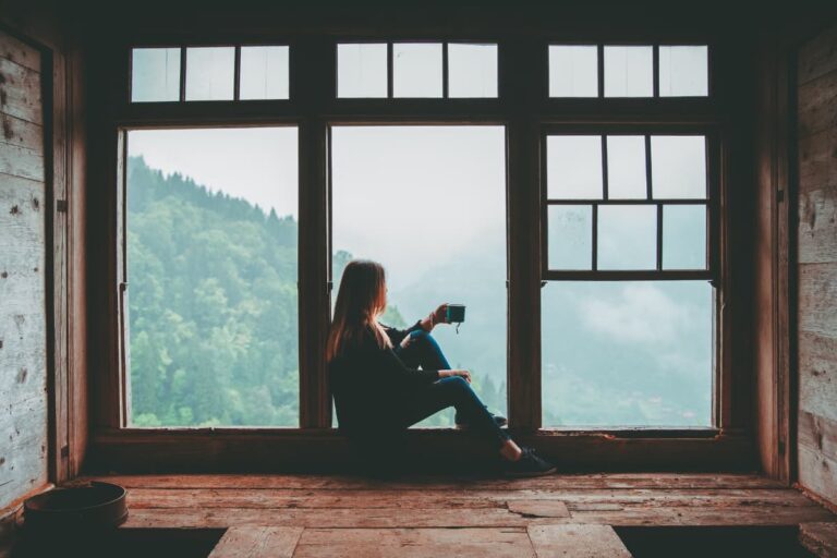 fear of rejection in a relationship - a woman thinks by the window