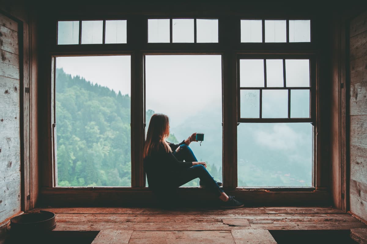 fear of rejection in a relationship - a woman thinks by the window