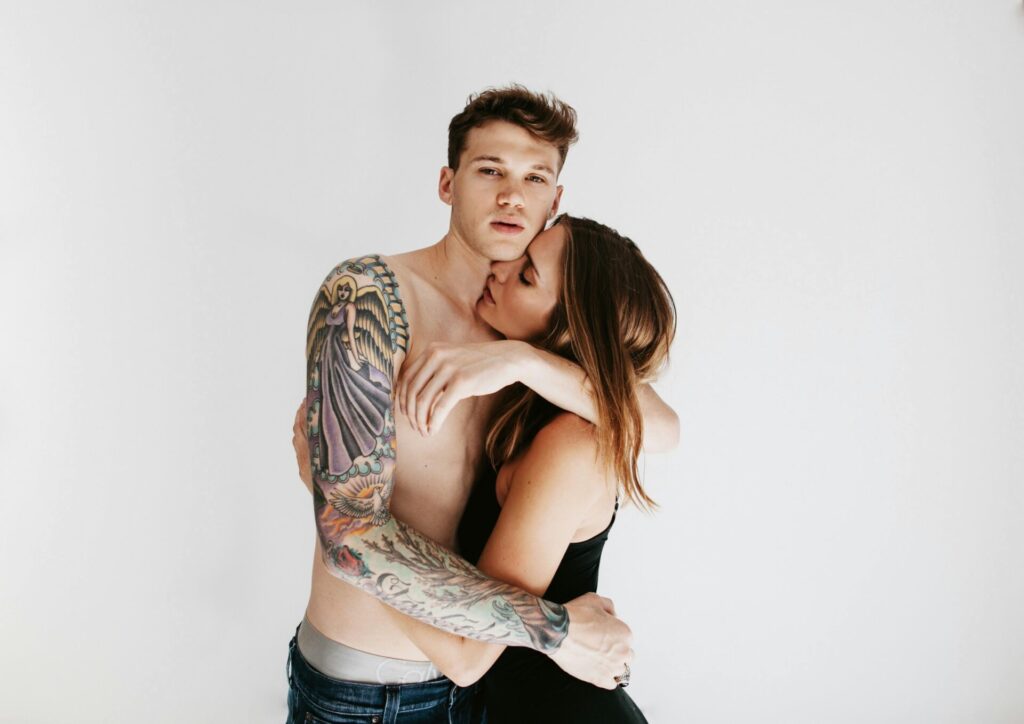 Man holding woman tightly in an intense embrace, symbolizing control in an emotionally abusive relationship