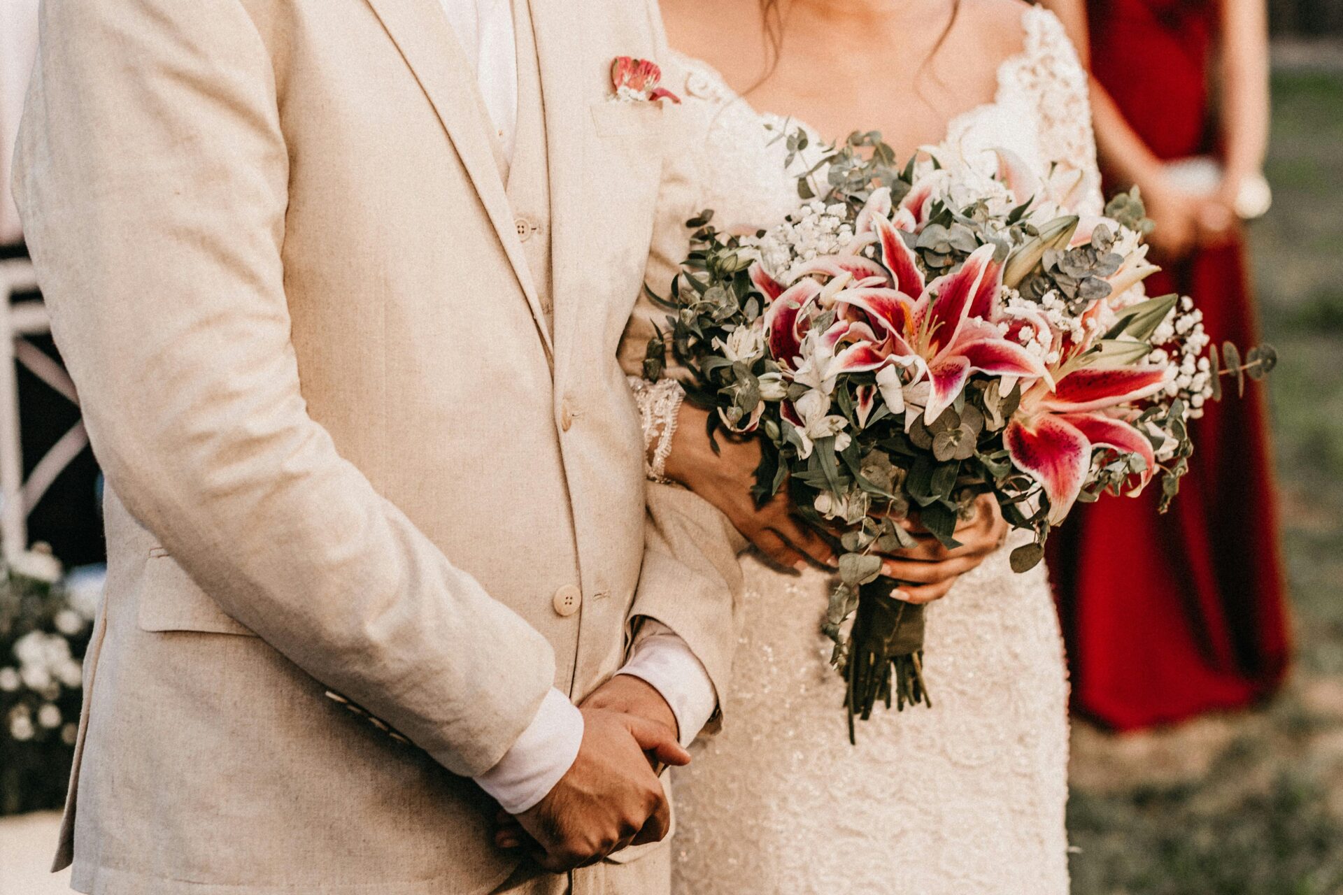Bride and groom captured from the waist down, with the bride holding a bouquet—symbolizing commitment and subtle signs you are ready for marriage.