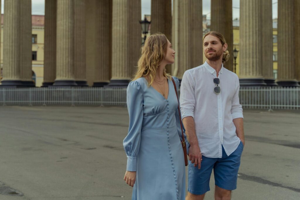Couple walking through the city, reunited after a long separation, showing the emotional highs and what kills long-distance relationships when connection fades.

