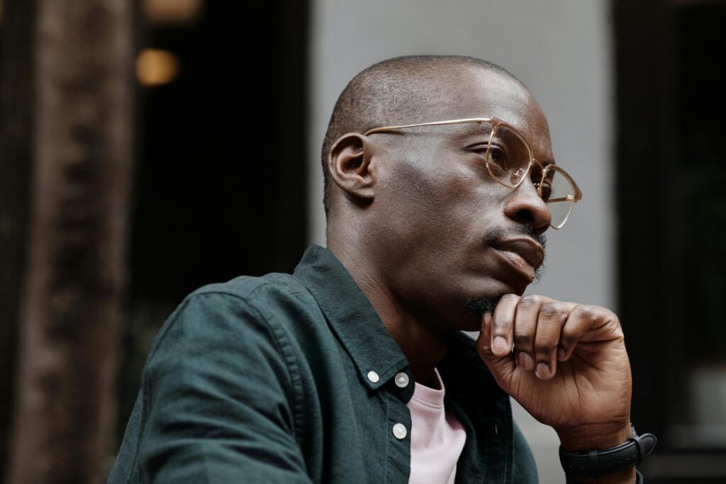 Thoughtful man reflecting deeply, symbolizing the common struggle and search for how to stop overthinking after a first date.