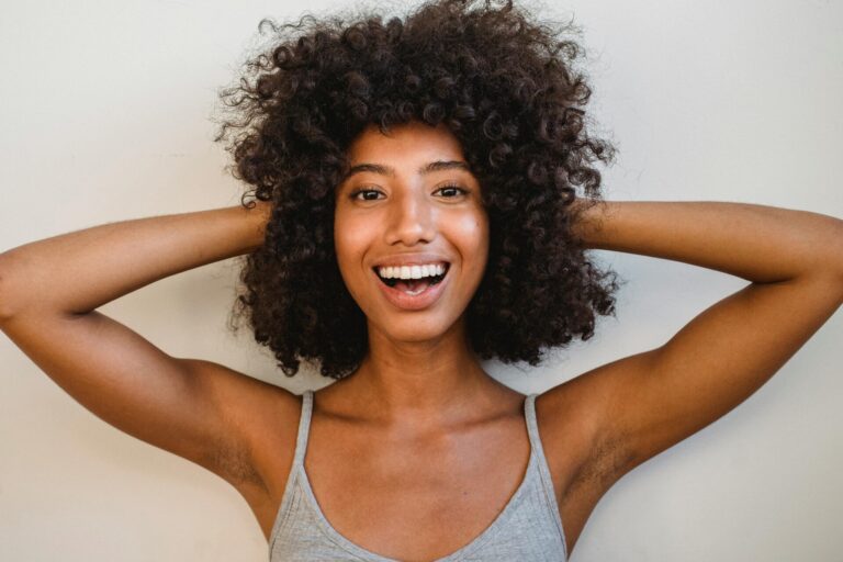 Dark-skinned woman smiling brightly, embodying the strength of inspirational quotes for a bad day