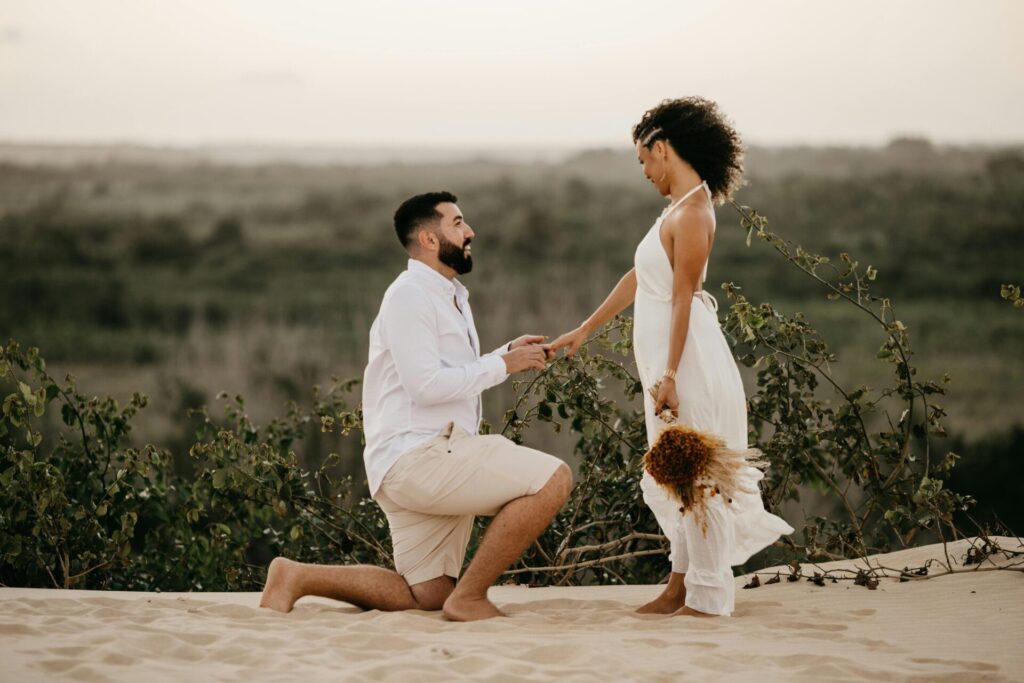 "Man kneeling to propose to a woman, a powerful moment that can reveal signs of fear of commitment in relationships when one partner feels uncertain or emotionally unprepared.