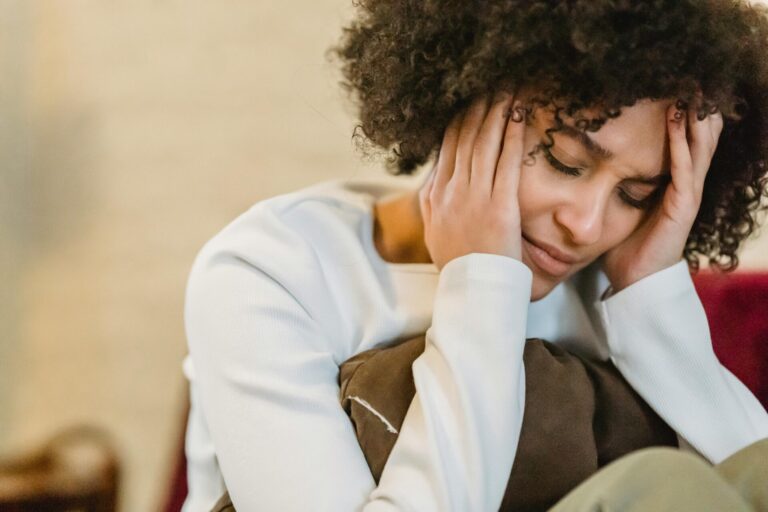 Woman feeling overwhelmed and sad, wondering what to do when you have bad day and everything feels too much.