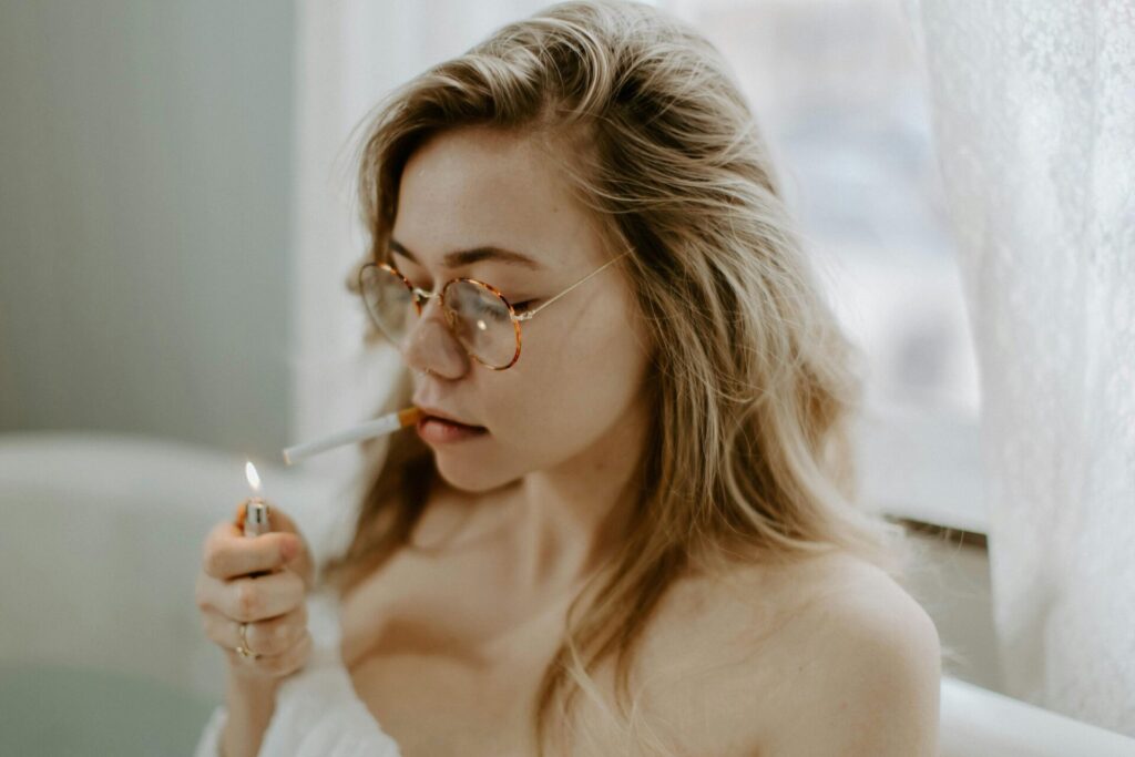 A woman smoking a cigarette — a visual reflection of why we develop bad habits when coping with stress or emotional discomfort.