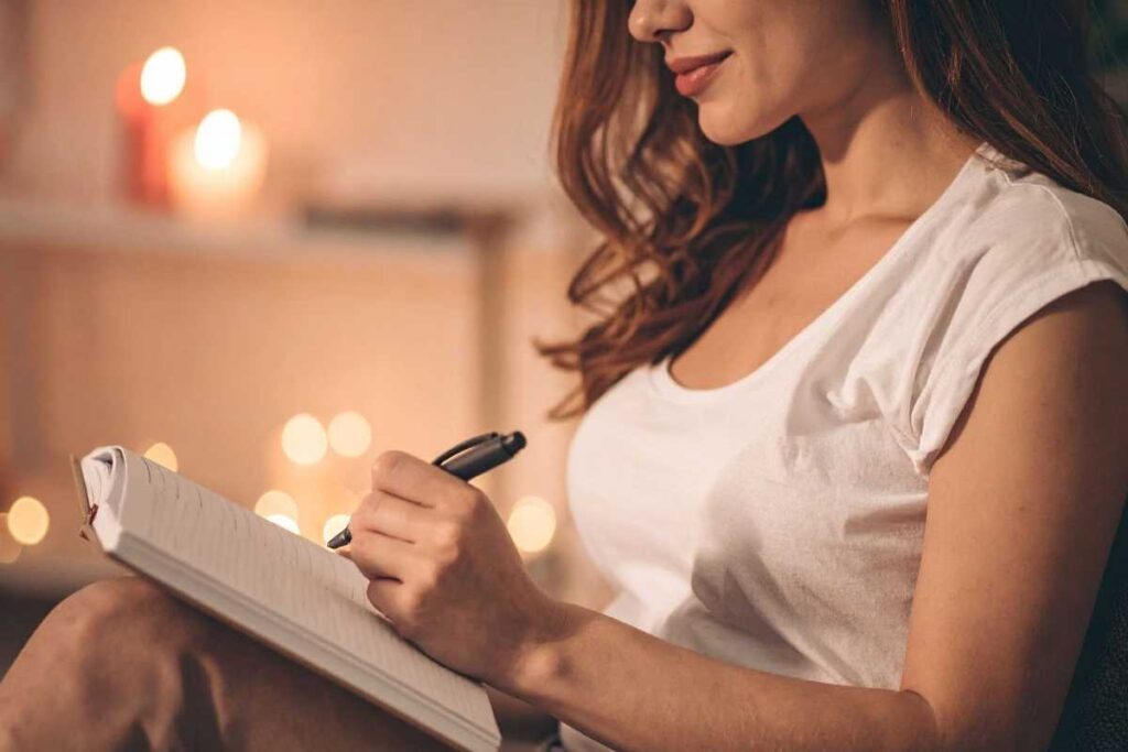 New year journal prompts: woman holding her notebook, ready to reflect and plan for a meaningful start to 2026