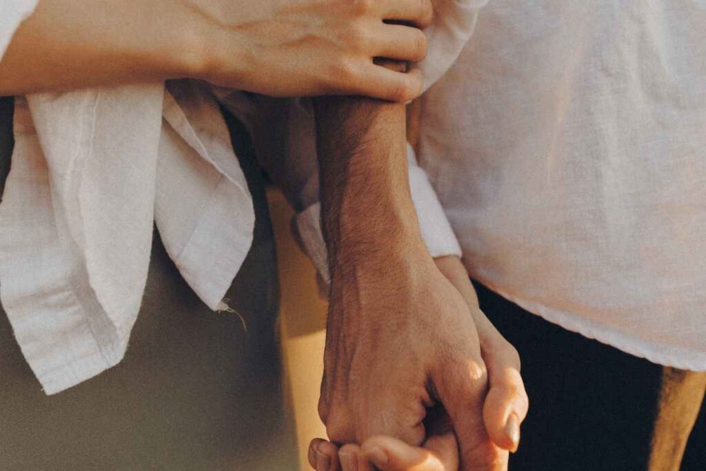 a couple holding hands intimately, symbolizing fast emotional attachment and early bonding