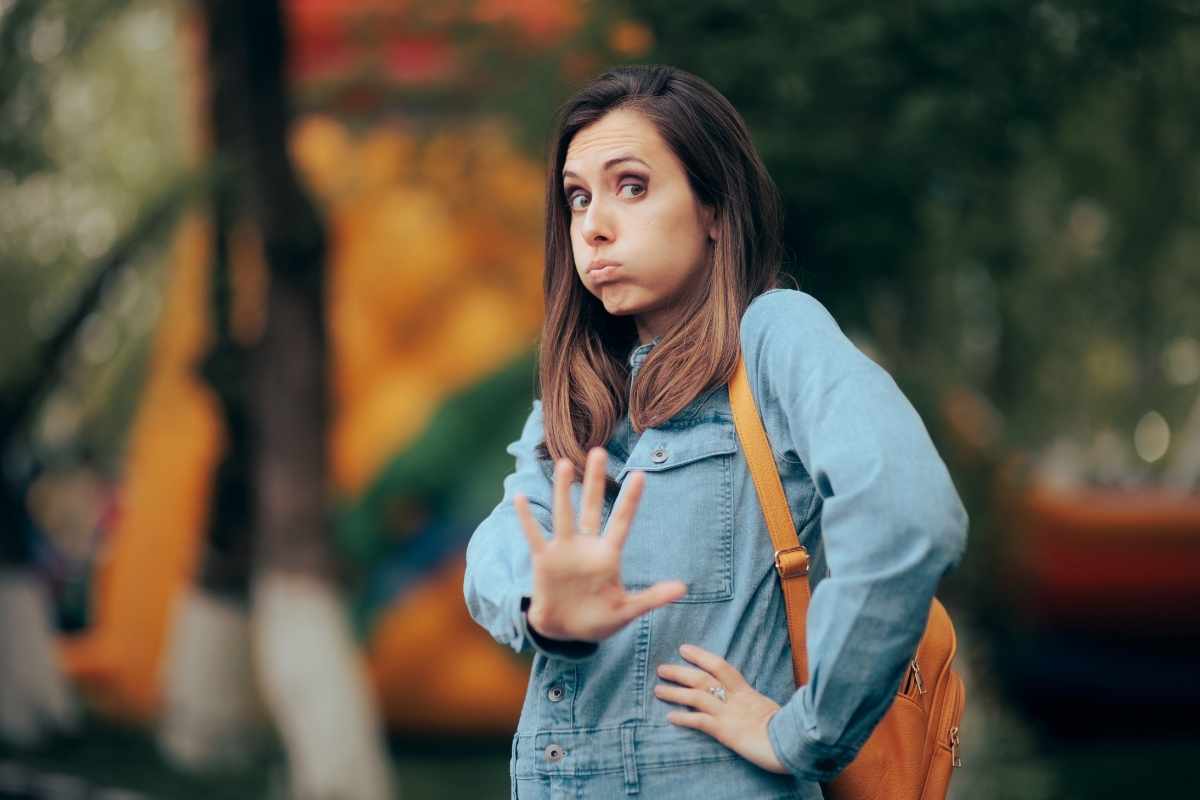 Signs you have weak boundaries: woman holding up her hand to say stop, representing the importance of setting personal limits
