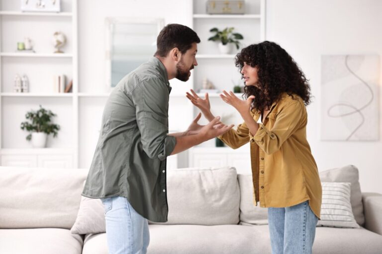 Couple arguing and gesturing angrily during a relationship conflict