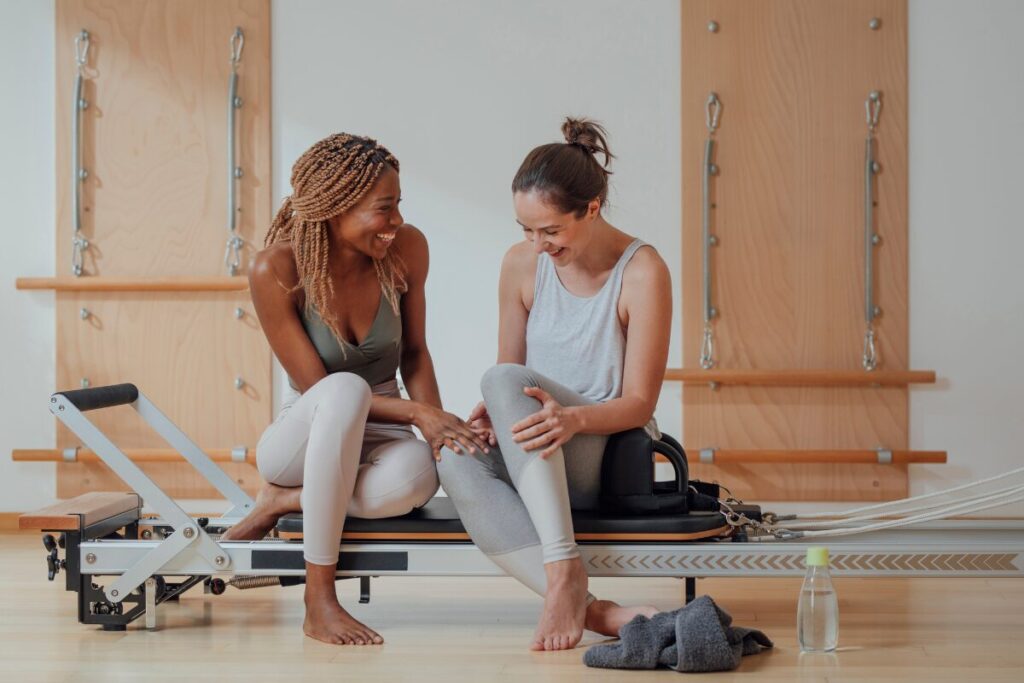 things you should never apologize for- two women talking in the gym
